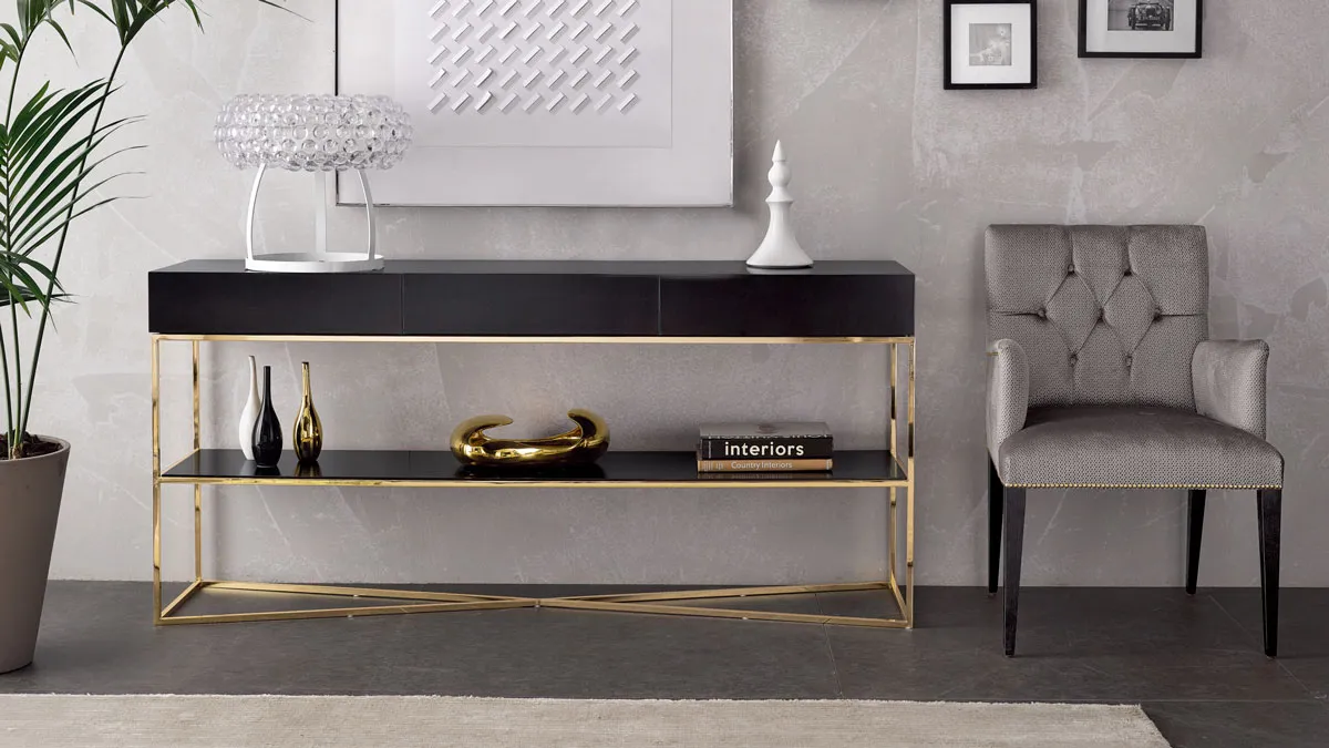 Poltroncina con schienale capitonn&egrave;, console in legno con base in metallo placcato oro in stile classico contemporaneo