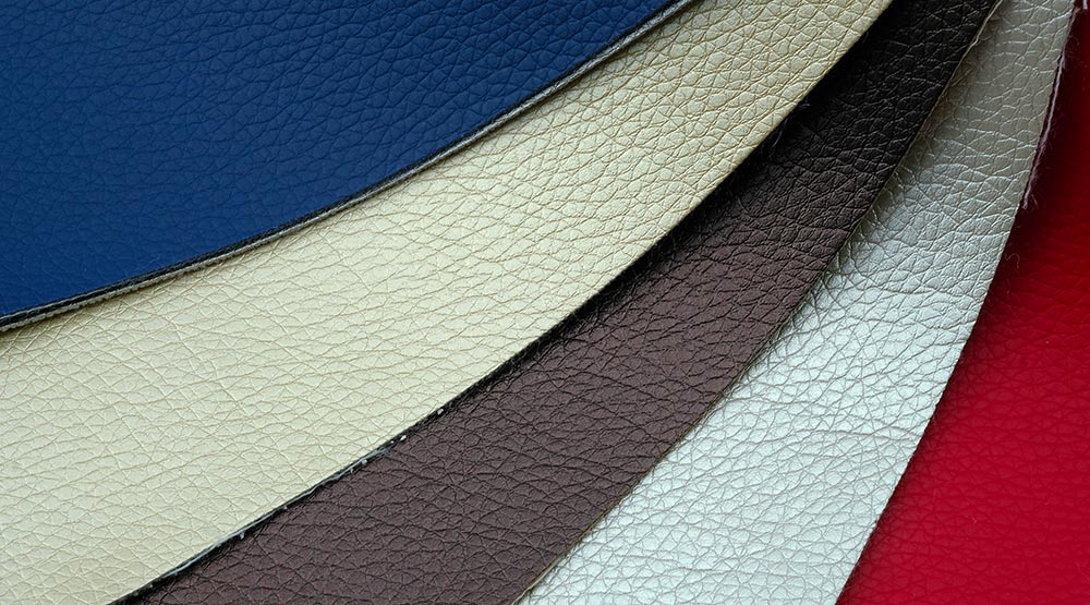 many pieces of faux leather for sale in different colors: white, back, blue, orange, yellow, green purple